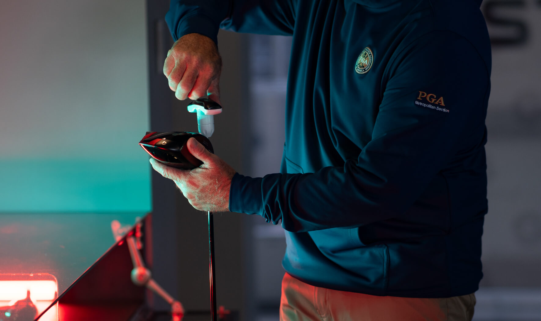 Close-up of a custom club being fine-tuned with a detailed fitting report process.